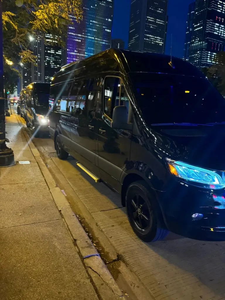 Black Mercedes Sprinter on a downtown Chicago street at night